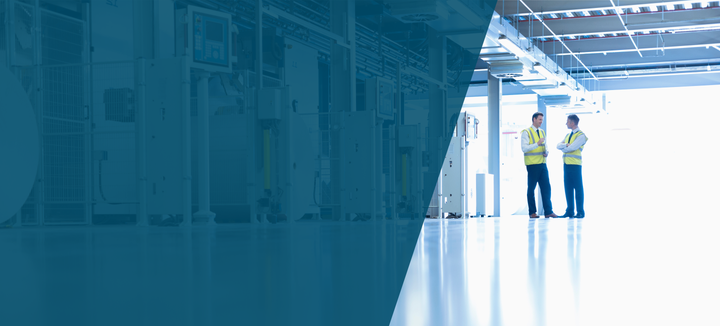 two men in the far ground among industrial machinery