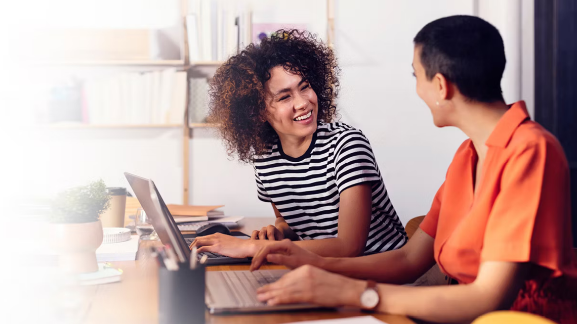 two channel partner managers smiling during a meeting because the channel partner management strategy that Richardson gave them is driving success
